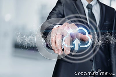 Businessman clicks on cloud computing data upload icon Stock Photo