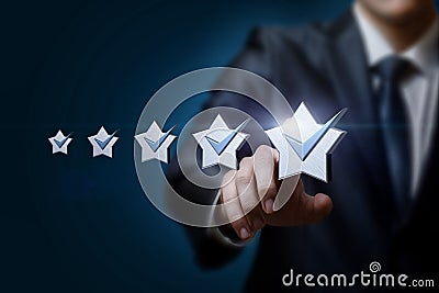 Businessman clik on a five star rating on a blue background Stock Photo