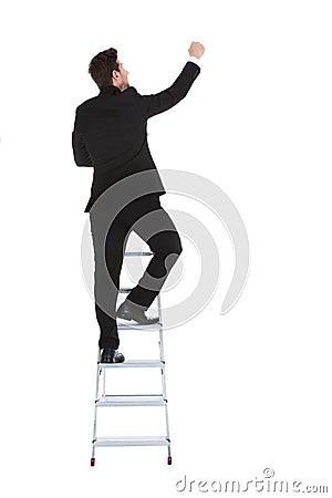 Businessman climbing career ladder Stock Photo