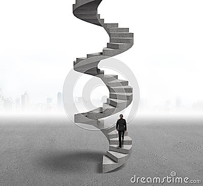 Businessman climbing concrete spiral staircase Stock Photo