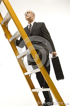 Businessman climbing ladder. Stock Photo