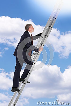 Businessman climbing a ladder in the sky Stock Photo