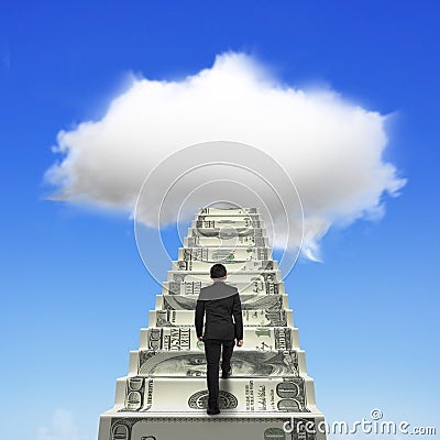 Businessman climbing the money stairs toward white cloud Stock Photo