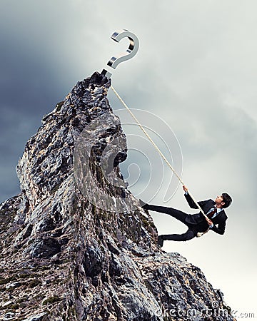 Businessman climbing mountain Stock Photo