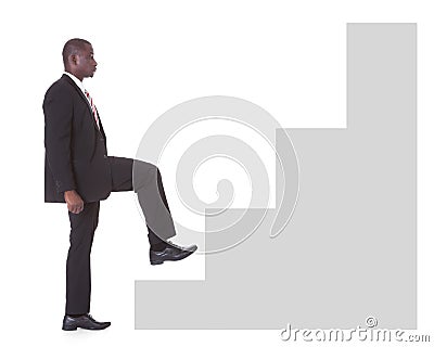 Businessman climbing steps Stock Photo