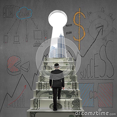 Businessman climbing to key shape door with business doodles Stock Photo