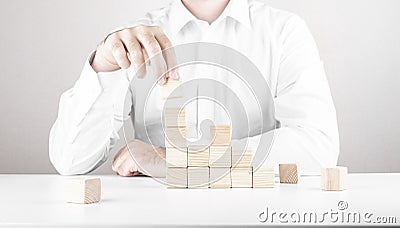 Businessman climbs the career ladder. Business concept from cubes Stock Photo