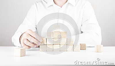 Businessman climbs the career ladder. Business concept from cubes Stock Photo