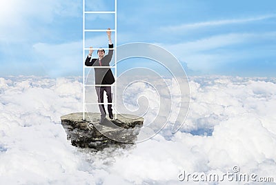 Businessman climbs stairs above clouds Stock Photo