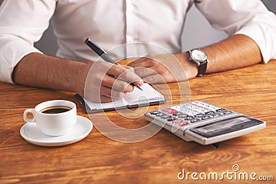 Businessman coffee calculator notebook Stock Photo