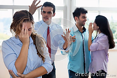 Businessman and colleagues bullying employee Stock Photo