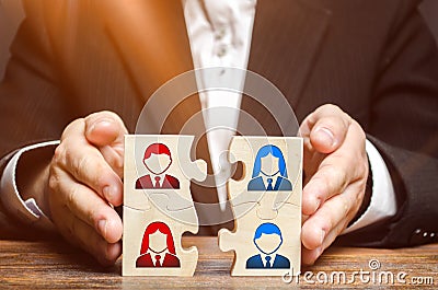 Businessman collects puzzles symbolizing the team of employees. Combining teams and people to perform work. The combination Stock Photo