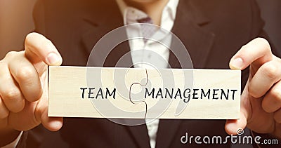 Businessman collects puzzles with the words Team management. Increase efficiency. Hiring and dismissal employees. Organization of Stock Photo