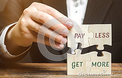 Businessman collects wooden puzzles with words Pay less get more. Offer discounts. Savings when buying. Big sale. The concept of Stock Photo
