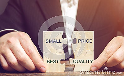 A businessman collects wooden puzzles with the words Small price - best quality. The concept of profitable deals for buyers. Low Stock Photo