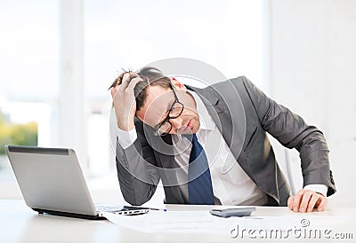 Businessman with computer, papers and calculator Stock Photo