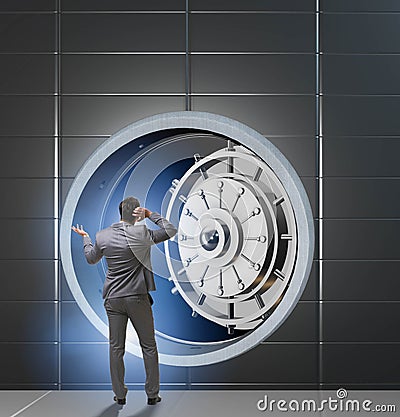 Businessman concerned about theft at banking vault door Stock Photo