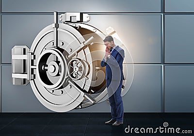 Businessman concerned about theft at banking vault door Stock Photo