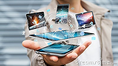 Businessman connecting tech devices with his mobile phone 3D rendering Stock Photo