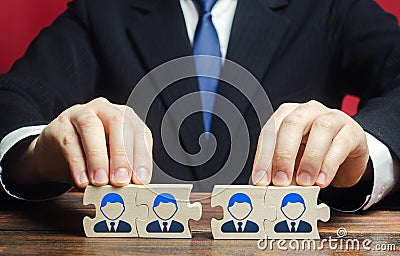 Businessman connects puzzles of workers employees into a single whole. Create effective specialists team for work on a new project Stock Photo