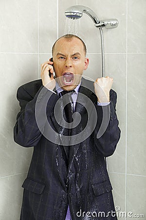 Businessman cooling down under a shower Stock Photo