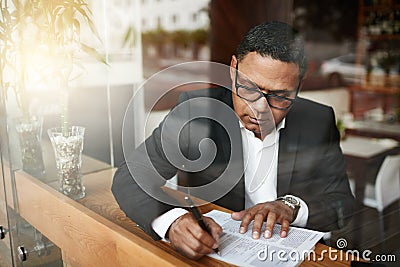 Businessman, corporate paperwork and writing in cafe for lawyer contract, legal document and glasses. Paralegal, person Stock Photo