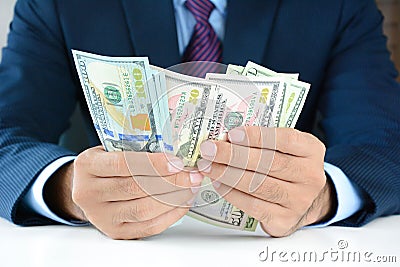 Businessman counting money,US dollar (USD) bills Stock Photo