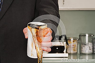 Businessman crushing coffee cup Stock Photo