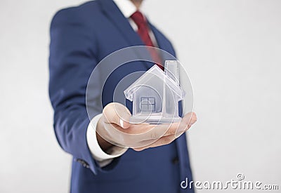 Businessman with crystal house in hand Stock Photo