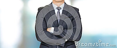 Businessman in dark gray suit crossing his arms Stock Photo