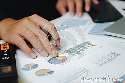 Businessman data document graph chart report marketing research development working at office with laptop Stock Photo