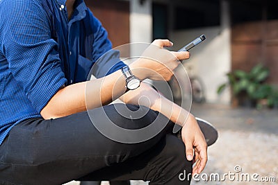 Businessman dealing business on smart mobile phone in front of peaceful home in rural countryside. Mobile office, Freelance, Lifes Stock Photo