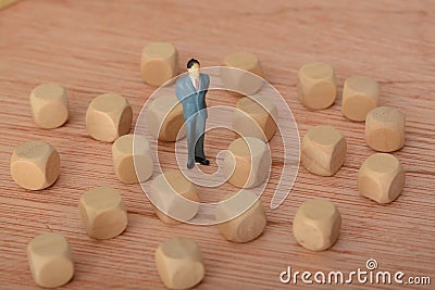 The businessman, deep in thought and surrounded by wooden blocks, pondered the problem and the challenge of development, searching Stock Photo