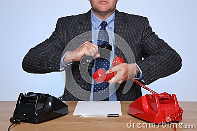 Businessman at desk on a conference call. Stock Photo