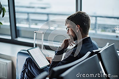 businessman with a digital tablet reading business documents. Stock Photo