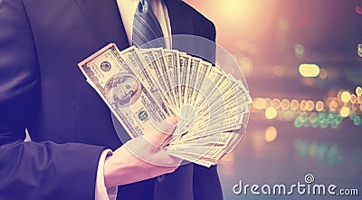 Businessman displaying spread of cash Stock Photo