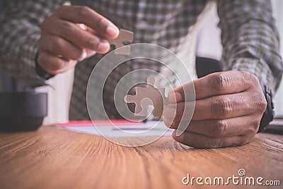 Businessman doing a jigsaw, concept of business sucessful Stock Photo