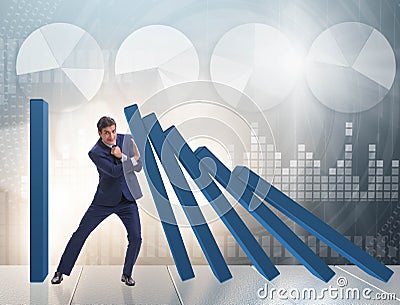 Businessman in domino effect business concept Stock Photo