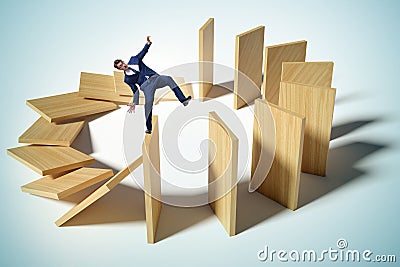 Businessman in domino effect concept Stock Photo