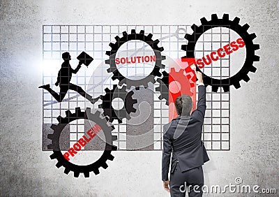 Businessman drawing gears and chart Stock Photo