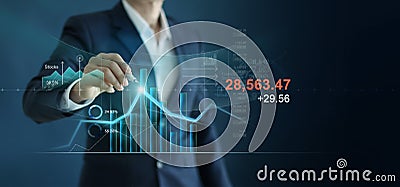 Businessman drawing growth graph 0and analyzing financial investment data, strategy and planing on blue background Stock Photo