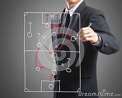 Businessman drawing tactic scheme on board Stock Photo