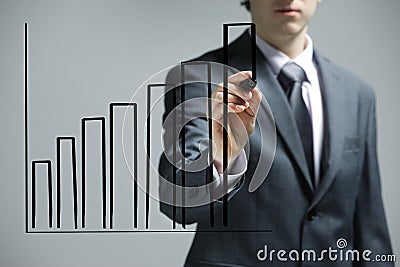 Businessman drawing a uptrend chart Stock Photo