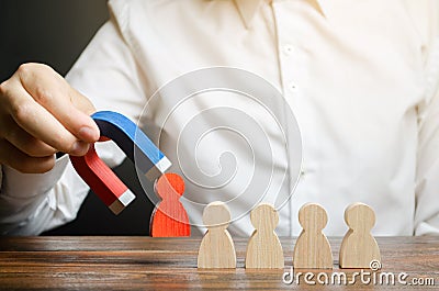 The businessman draws a red figure from the team with a magnet. The concept of toxic and non-competent worker Stock Photo