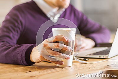 Businessman drinking coffee using laptop Stock Photo