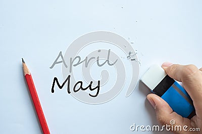 Businessman erasing April text change to May. month and Season change concept Stock Photo
