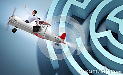 Businessman escaping from maze on airplane Stock Photo