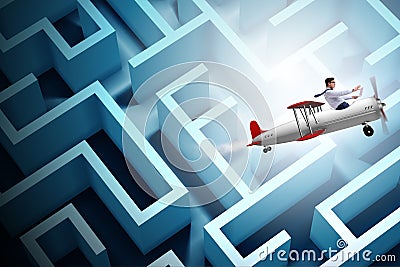 The businessman escaping from maze on airplane Stock Photo