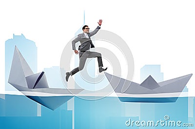 Businessman escaping sunken paper boat ship Stock Photo