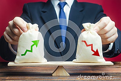 A businessman estimates the ratio of income to expenses. Profitability and return on investment and business summary. Profit Stock Photo